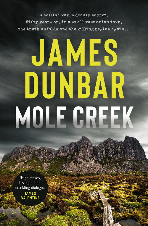 Book cover for 'Mole Creek' by James Dunbar, featuring a dramatic mountain landscape with dark rocky peaks, green mossy ground, and large yellow and white title text over a stormy sky.