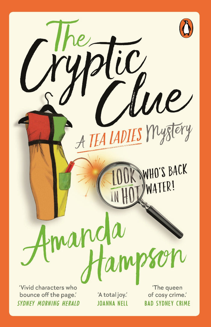 Book cover of 'The Cryptic Clue' by Amanda Hampson with a magnifying glass, hanger, and dress on an orange background.
