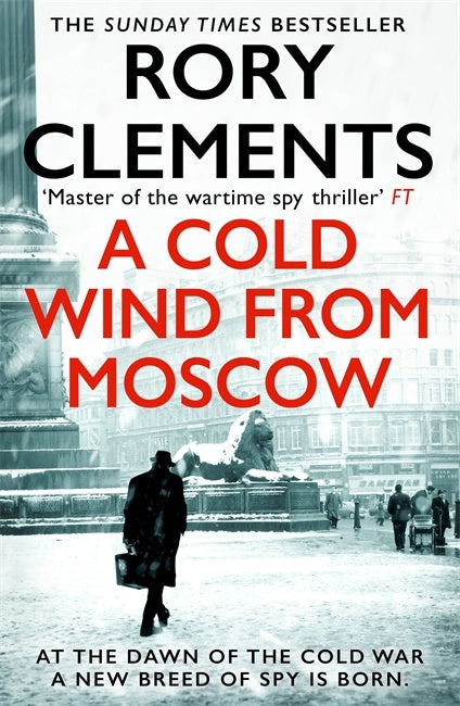 Book cover of 'A Cold Wind from Moscow' by Rory Clements with a snowy cityscape background.