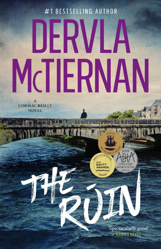Book cover of 'The Ruin' by Dervla McTiernan with a bridge and water scene.