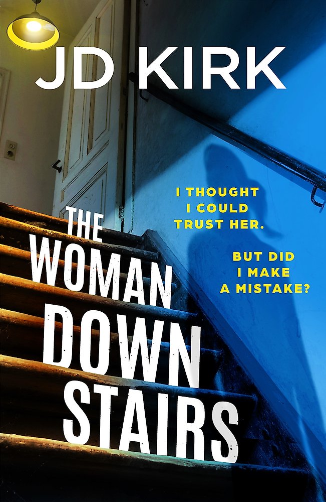 Book cover of 'The Woman Downstairs' by JD Kirk with a blue wall and staircase.