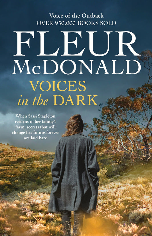 Book cover of 'Voices in the Dark' by Fleur McDonald with a person standing in a field.
