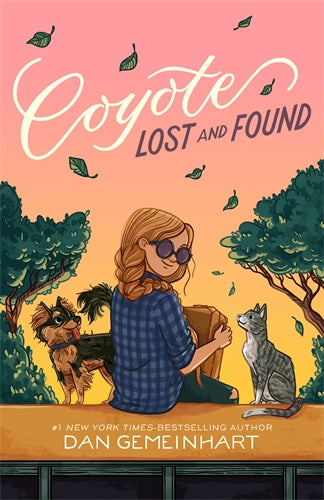 Book cover of 'Coyote Lost and Found' with a woman, dog, and cat in a park setting.