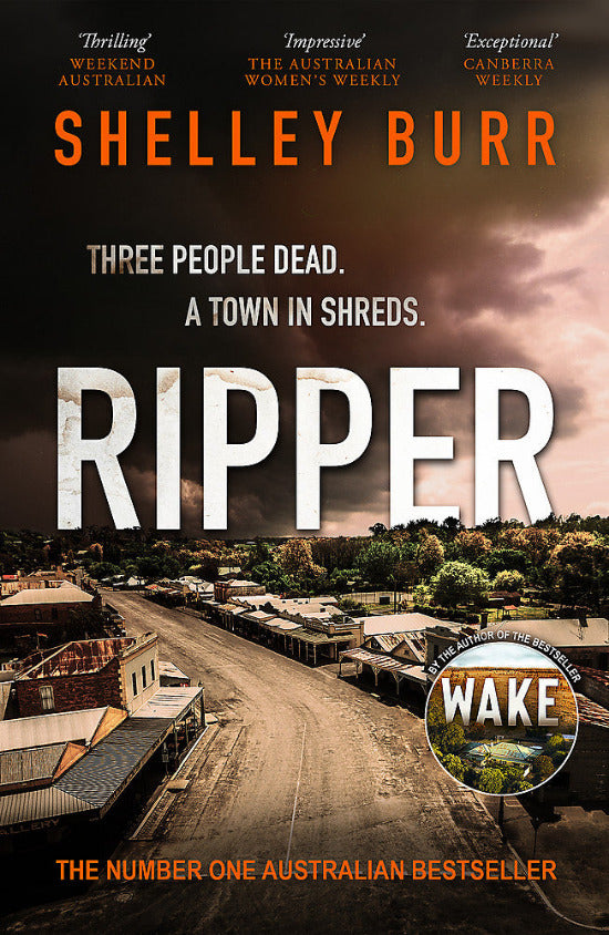 Book cover for 'Ripper' by Shelley Burr, featuring a dark aerial town scene with large white title text and orange author text at the top.