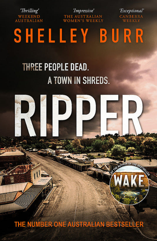 Book cover for 'Ripper' by Shelley Burr, featuring a dark aerial town scene with large white title text and orange author text at the top.