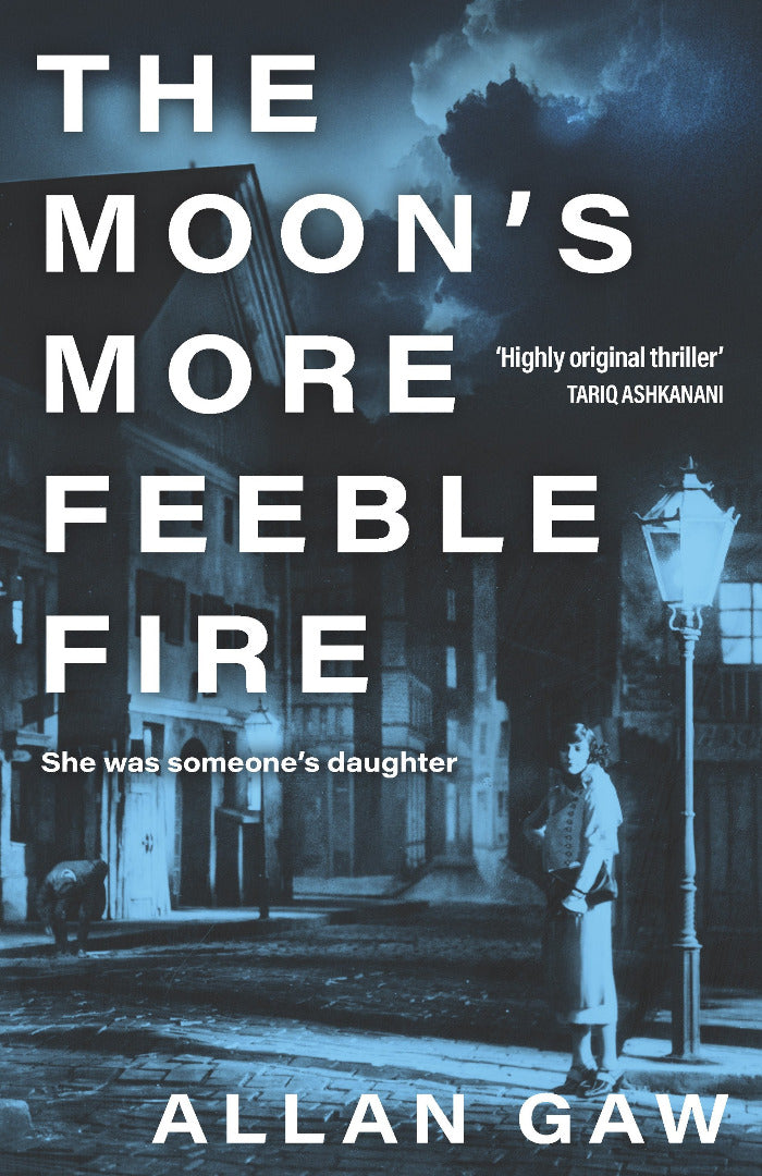 Book cover of 'The Moon's More Feeble Fire' with a dark, urban street scene and a person standing under a street lamp.