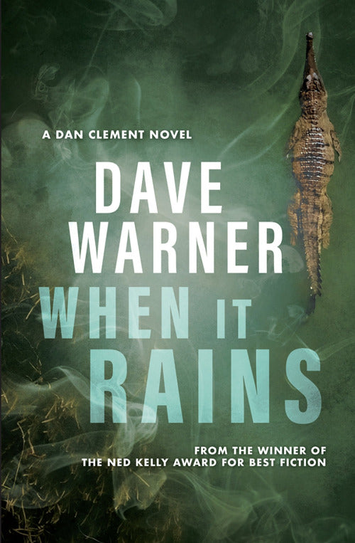 Book cover of 'When It Rains' by Dave Warner with a crocodile and green smoke background.